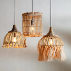 Three woven pendant lights hanging against a plain wall.