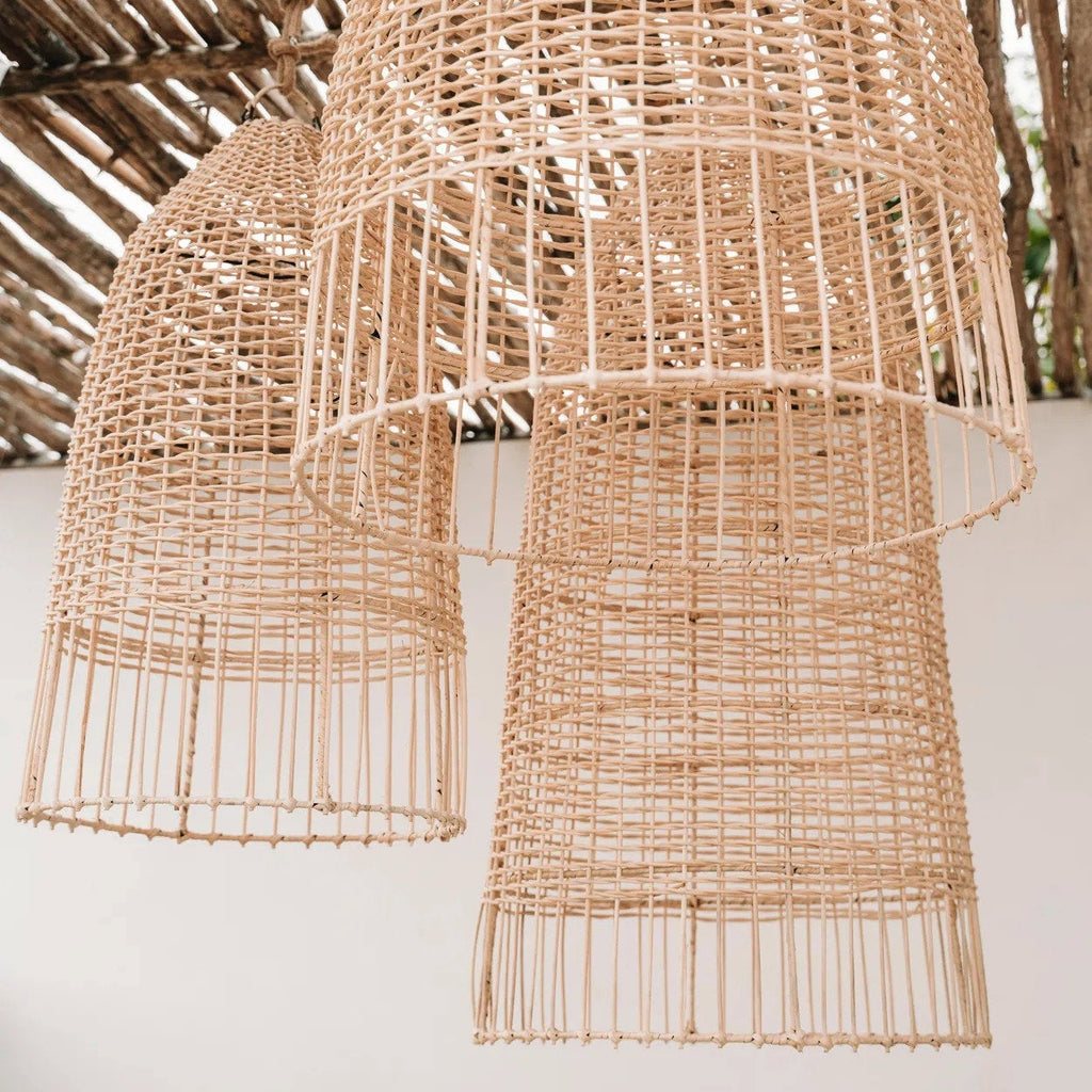 Woven rattan pendant lights against a neutral background