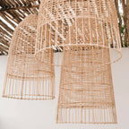 Woven rattan pendant lights against a neutral background